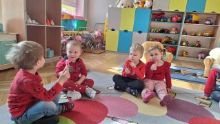 Dzieci siedzą na dywanie