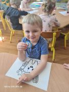 Chłopiec prezentuje prezenty otrzymane od studentek 