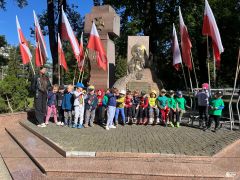 Dzieci pozują przy pomniku