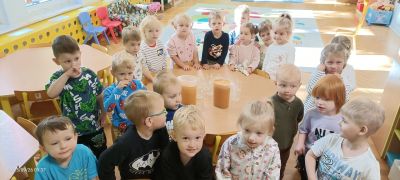 Maleństwa czekają na spróbowanie soku jabłkowego